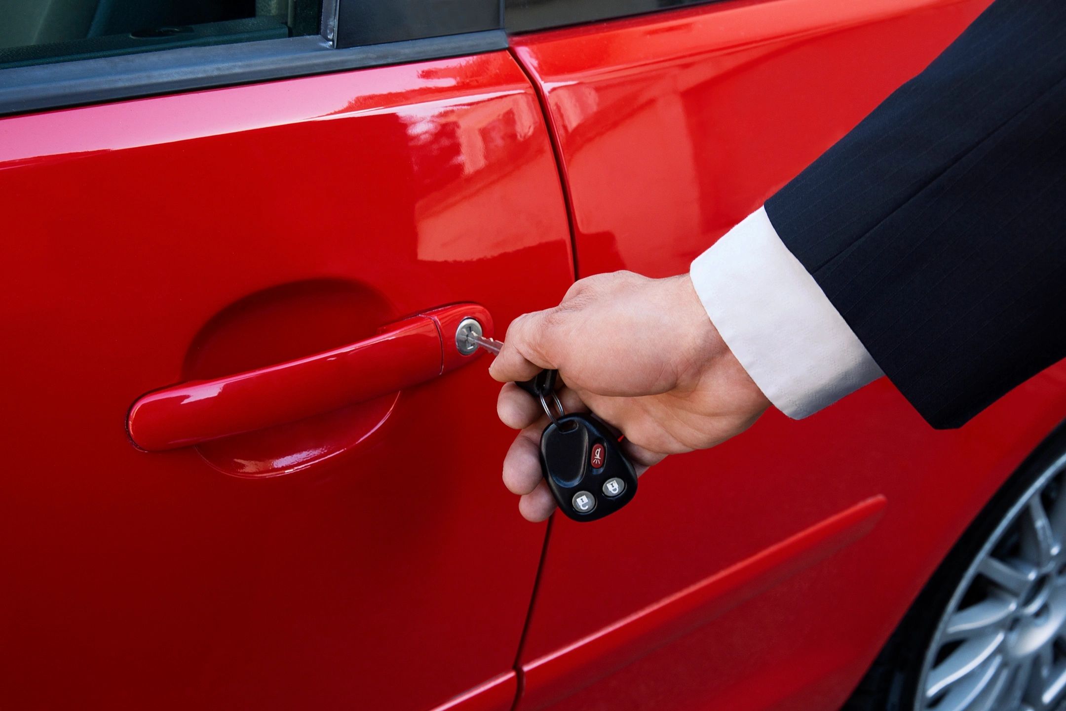 putting key into car